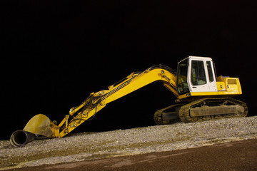 excavator on night pebble beach mounting tube