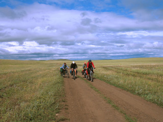 four cyclists go to road.