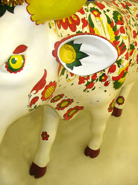 sculpture of a ornamentaly painted cow on white