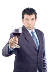 man in a suit tasting wine