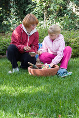 mother and daughter planting tulips