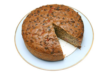 home made fruit cake with a slice missing.