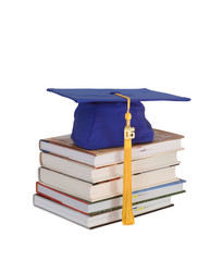 graduation cap on books