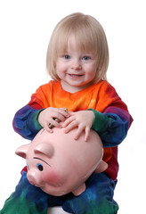 toddler holding a piggy bank