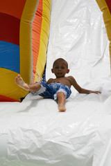 kid riding a slide