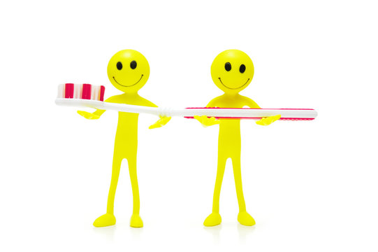 two smilies holding toothbrush isolated on white