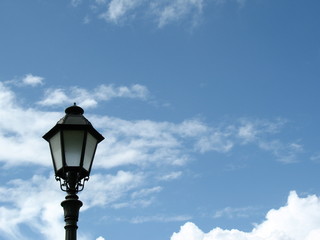 Fototapeta na wymiar single lamp post against blue sky