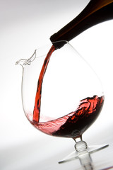 pouring red wine into decanter