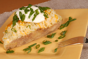 twice baked potato with scallions, cheese and sour cream