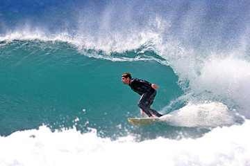 surfer executing a bottom turn - obrazy, fototapety, plakaty