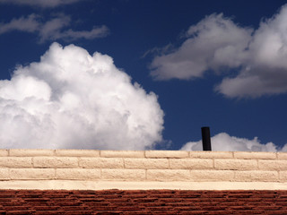 brick wall clouds and blue sky