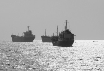 three small oil tanker at anchor
