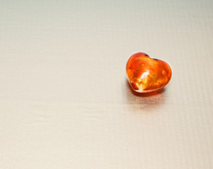 glass heart on silver background