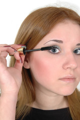beautiful girl fixing eyelashes