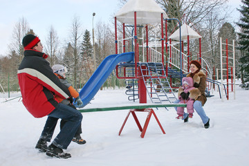 winter family on seesaw