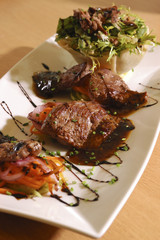 pieces of fried meat with vegetables and salade