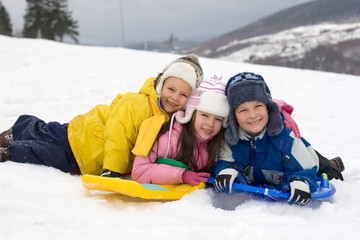 Fototapeta na wymiar kids sliding in fresh snow