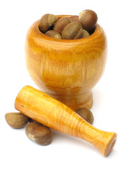 wooden mortar and pestle with chestnuts