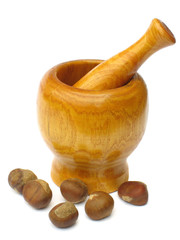 wooden mortar and pestle with chestnuts