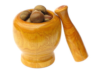 wooden mortar and pestle with chestnuts