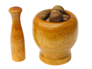wooden mortar and pestle with chestnuts