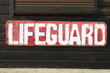 old weathered lifeguard sign on a beach in cornwal