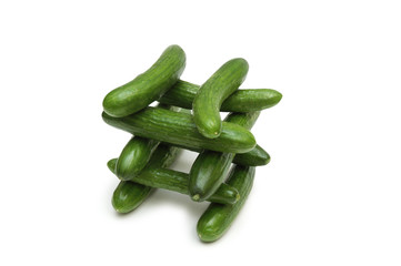 pyramid of green cucumbers isolated on the white b