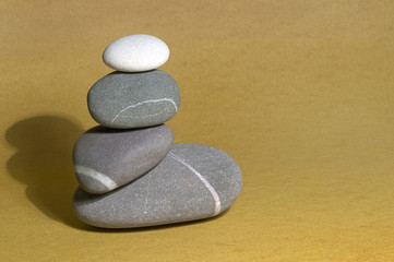 Fototapeta na wymiar pebble sculpture on sand