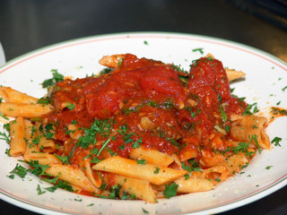 ziti with chunky tomato sauce in italian restaurant