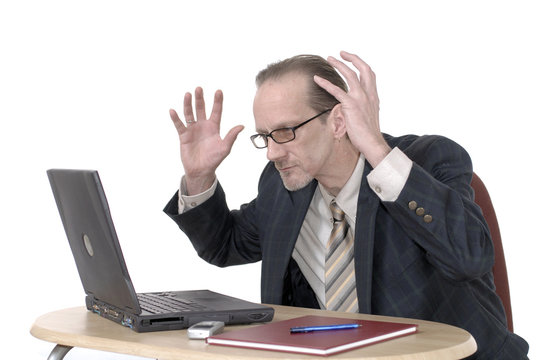 dissapointed businessman working on laptop
