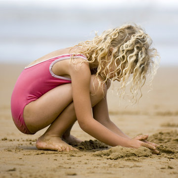 fillette jouant dans le sable