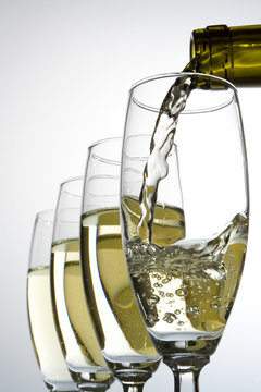 filling wineglasses with wine