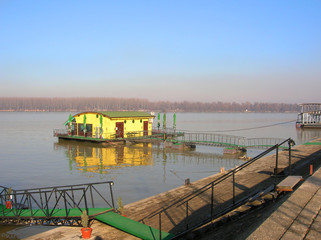 small yellow house on the water