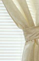 detail of tied-back curtain and blinds