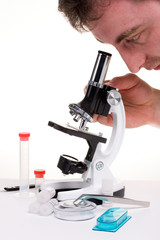 man researching things with microscope
