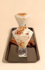 two glasses of rice pudding with cinnamon