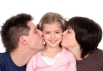 parents kissing their daughter