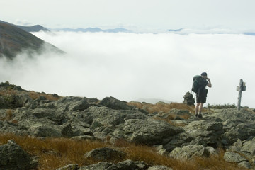 hiker above clouds