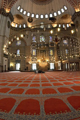 blue mosque interior with chandelies and carpet. - 2361961