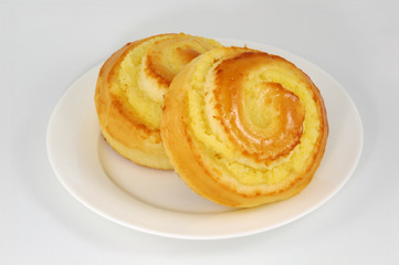 two sweet buns on white plate