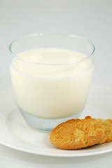 cookies on white plate and glass of milk