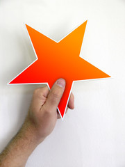 hand holding orange red star