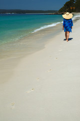 woman is walking on a tropical beach