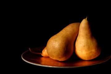 pears on gold against black