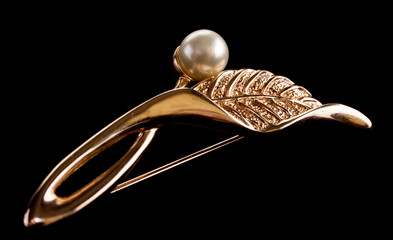 golden ear-ring as a leaf with pearl