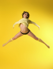 Fototapeta na wymiar pretty model happy jumping on yellow
