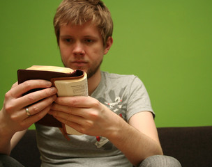 young man reading small bible