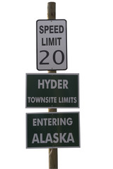 three road signs on a pole