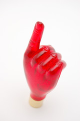 red glass hand with index finger on white