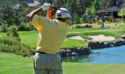 close-up of a golfer hitting over water
